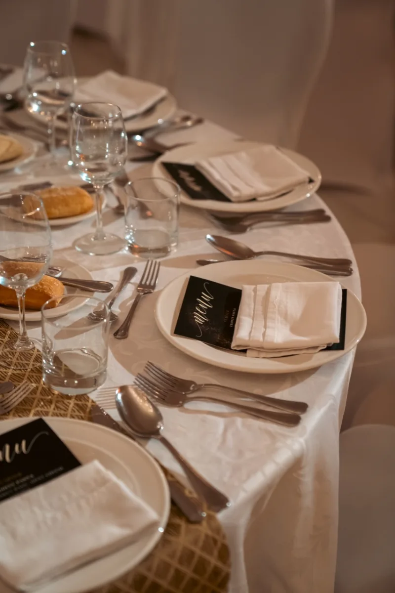 Elegant event table set with glassware, menus and folded napkins